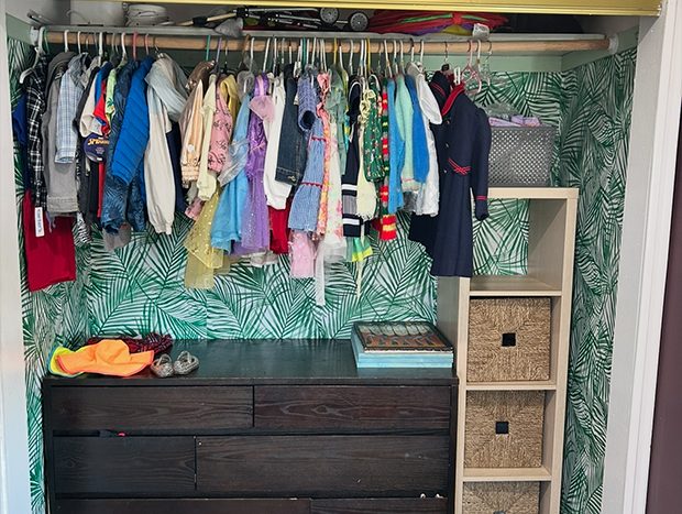 Neatly organized kids closet with sorted clothes and storage baskets