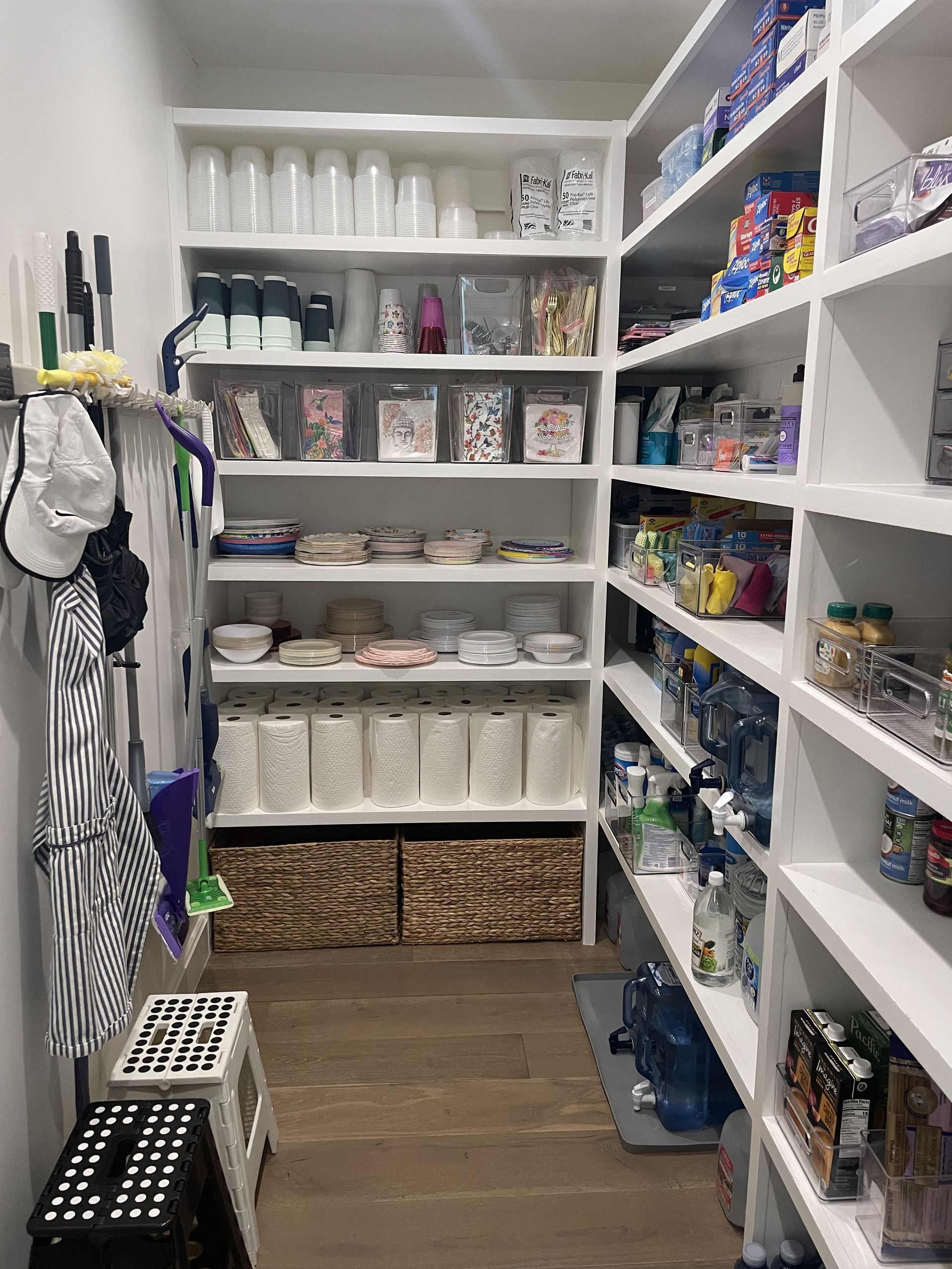 Large organized pantry with paper goods, plates, and supplies